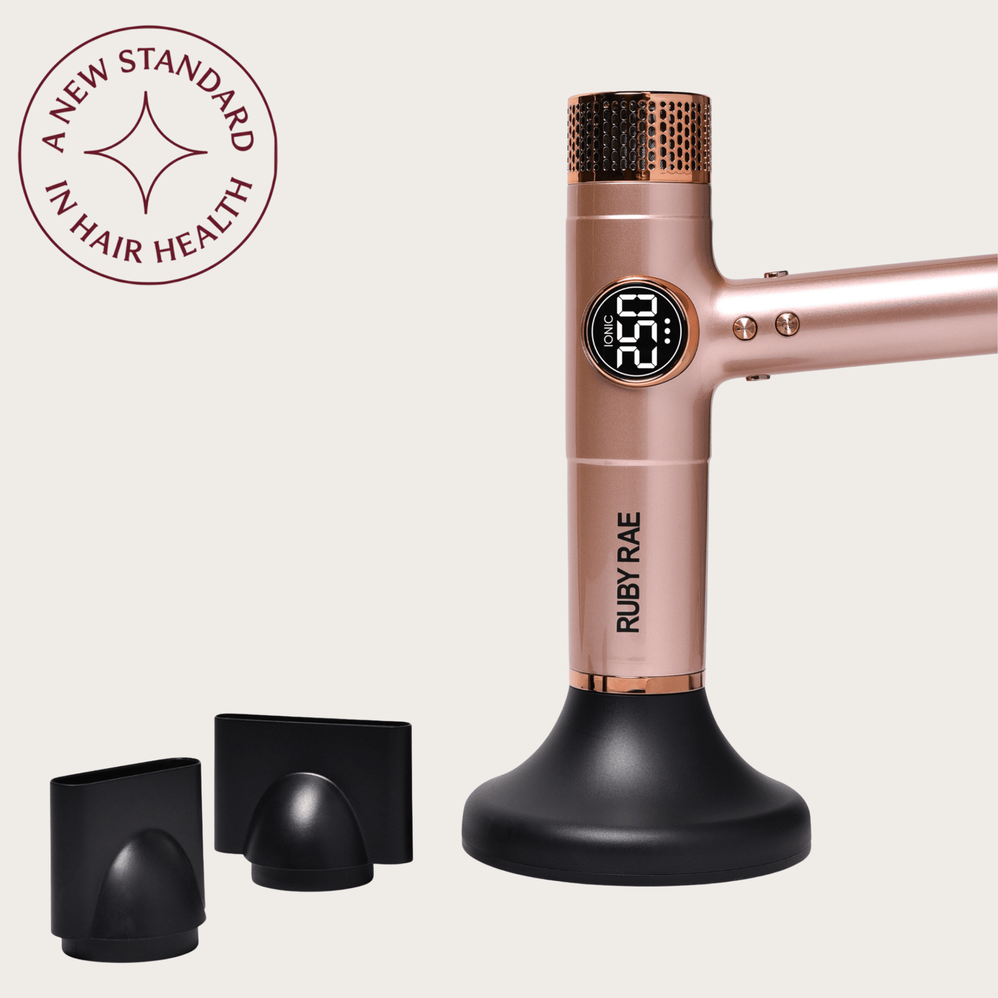 Rose gold hair dryer with attachments on a beige background, featuring the Ruby Rae brand.